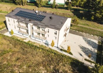 Edificio residenziale moderno visto dall&rsquo;alto con impianto fotovoltaico sul tetto